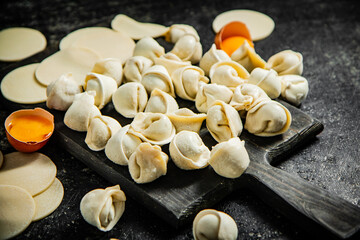 Canvas Print - Raw dumplings on cutting board with egg.