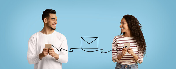 Wall Mural - Smiling Arab Man And Woman Holding Smartphones Connected With Envelope Shape String