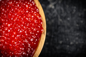 Sticker - Red caviar in a wooden plate. 