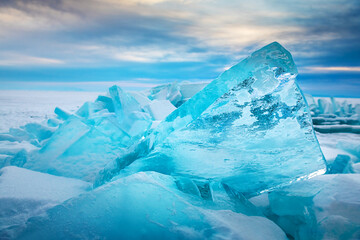 Wall Mural - Blue transparent ice on Baikal lake at sunrise.