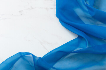 blue cloth on white marble background