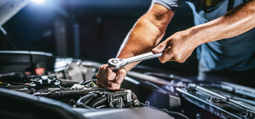 auto mechanic working in garage. repair service.