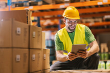 An Export And Import Firm Worker Is Tracking Inventory On Tablet And Smiling At It.