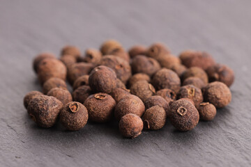 Poster - Black allspice in peas on a stone gray plate