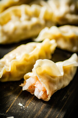 Sticker - Gyoza dumplings with shrimp on a cutting board. 