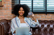 © kanpisut - Young woman consumer holding credit card and laptop buying online at home. Woman shipping online with credit card in hand. Women using laptop technology paying credit card shopping online