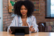 © kanpisut - Beautiful businesswoman working on laptop in bright modern office