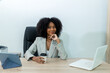 © kanpisut - Beautiful businesswoman working on laptop in bright modern office
