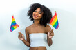 © kanpisut - Young woman holding LGBT rainbow flag. Woman holds a flag of the LGBT community .