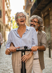 Modern senior couple with electric scooter