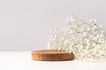 beauty cosmetic product presentation scene made with a wooden plate and wild flowers. summer mood ba