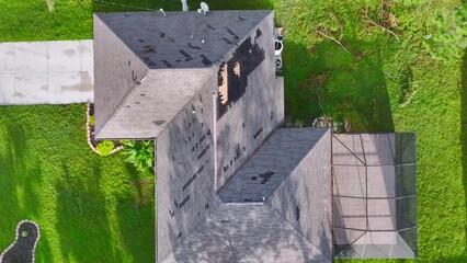 Poster - Damaged house roof with missing shingles after hurricane Ian in Florida. Consequences of natural disaster