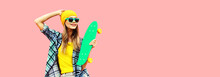 Summer Portrait Of Happy Smiling Young Woman With Skateboard Wearing Colorful Clothes Looking Away On Pink Background, Blank Copy Space For Advertising Text