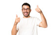 Young handsome caucasian man over isolated chroma key background giving a thumbs up gesture