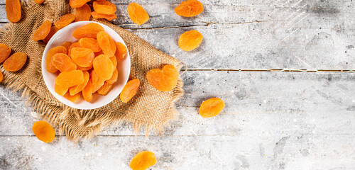 Wall Mural - Fragrant dried apricots in a bowl on the table. 