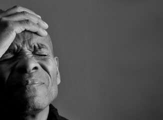 men praying to God with emotion on grey black background with people stock photo