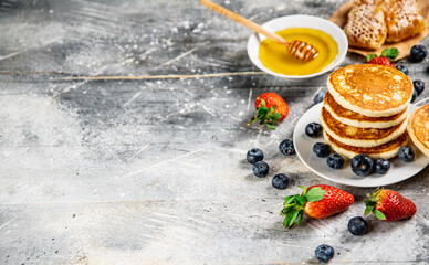 Wall Mural - Pancakes in a plate with berries and honey. 