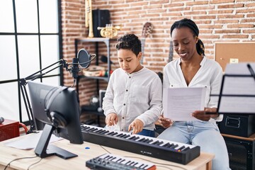 Poster - African american mother and son student learning play piano at music studio