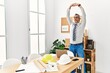 © Krakenimages.com - Middle age grey-haired man architect stretching at office