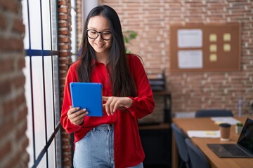 Sticker - Young chinese woman business worker smiling confident using touchpad at office