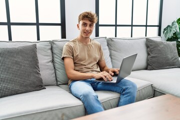 Sticker - Young caucasian man smiling confident using laptop at home