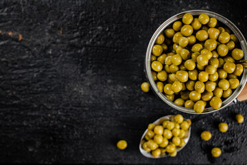 Poster - An open tin can with green peas. 