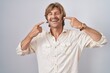 © Krakenimages.com - Middle age man standing over isolated background smiling cheerful showing and pointing with fingers teeth and mouth. dental health concept.