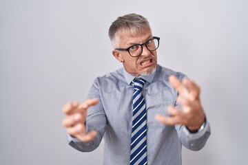 Sticker - Hispanic business man with grey hair wearing glasses shouting frustrated with rage, hands trying to strangle, yelling mad