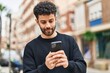 © Krakenimages.com - Young arab man smiling confident using smartphone at street