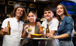 © JackF - Group photo of cheerful friends meeting at bar, dirinking beer, looking at camera and smiling.
