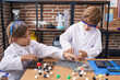 © Krakenimages.com - Brother and sister students doing experiment at laboratory classroom