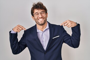 Sticker - Hispanic business man wearing glasses looking confident with smile on face, pointing oneself with fingers proud and happy.