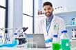 © Krakenimages.com - Young hispanic man wearing scientist uniform using laptop at laboratory
