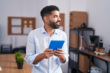 Sticker - Young arab man business worker smiling confident using touchpad at office