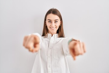 Sticker - Young caucasian woman standing over isolated background pointing to you and the camera with fingers, smiling positive and cheerful