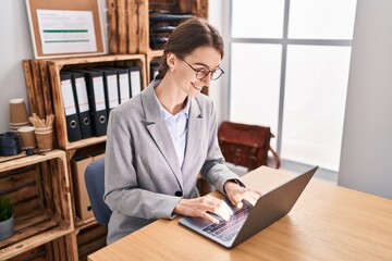 Poster - Young caucasian woman business worker using laptop working at office