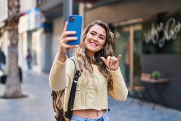 Sticker - Young woman tourist making selfie by the smartphone at street