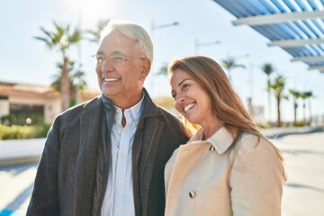 Sticker - Middle age man and woman couple hugging each other standing at park