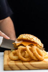 Burger cheese with potato in wooden table and black backgournd 