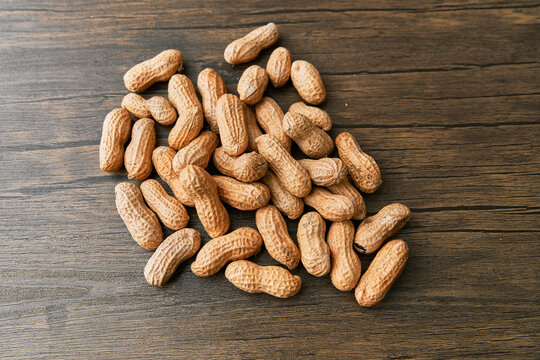 Image of bunch of peanuts on a wooden table