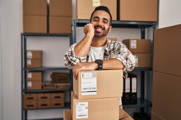 Sticker - Young hispanic man ecommerce business worker leaning on packages at office