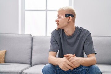 Sticker - Young caucasian man wearing virtual reality glasses looking to side, relax profile pose with natural face with confident smile.