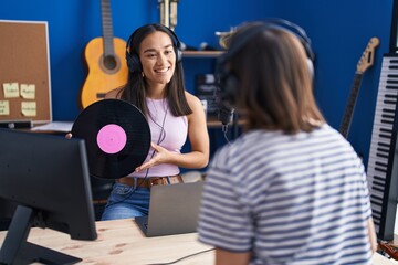 Sticker - Two women musicians listening to music holding vinyl disc at music studio