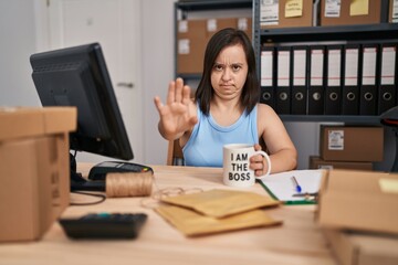 Sticker - Hispanic girl with down syndrome working at small business ecommerce with open hand doing stop sign with serious and confident expression, defense gesture