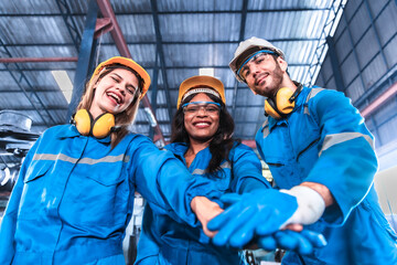 Young people worker in protective uniform operating machine at factory Industrial.People working in industry.Portrait of Female Engineer looking camera at work place.