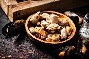 Canvas Print - Pickled mussels in a wooden plate on the table. 