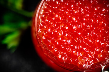 Canvas Print - Red caviar in a glass jar with parsley. 