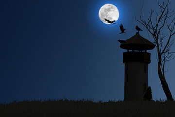 Wall Mural - Silhouette of a crow perching and flying on an old watchtower beside a dry tree on a blurred full moon night.