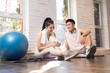 © View Stock - Young couple sitting on the ground to rest after workout