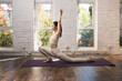 © View Stock - Young woman doing yoga indoors
